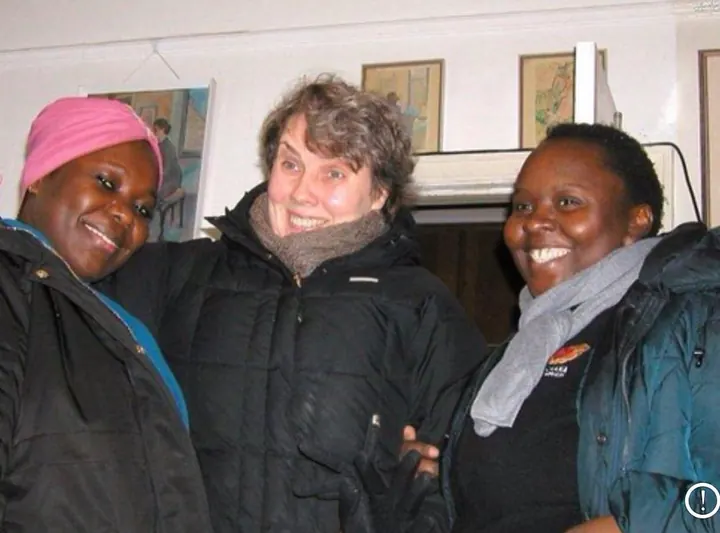 Muzaana carers out with a client on a bright day, all three laughing together.